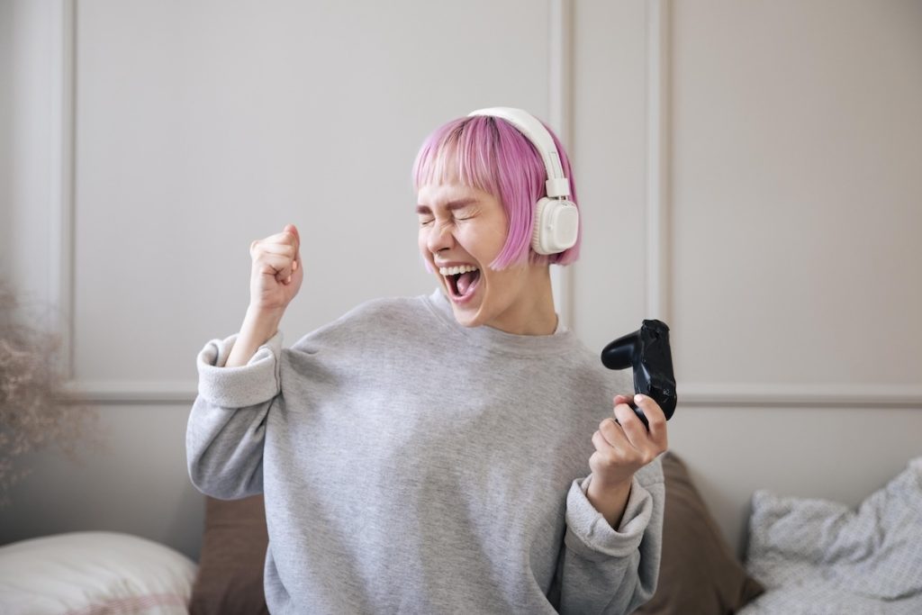 young woman with pink hair playing videogame 1 young woman with pink hair playing videogame 1